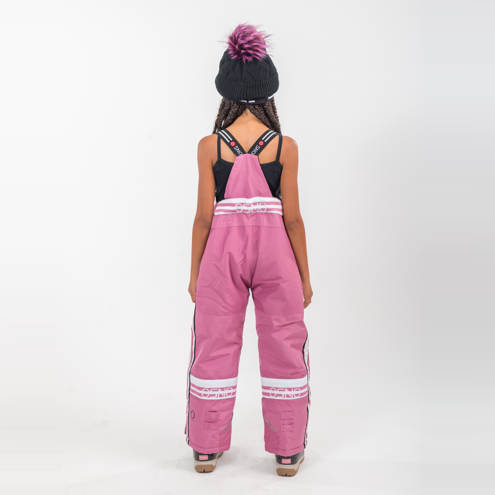Person wearing pink overalls with white stripes on a white background