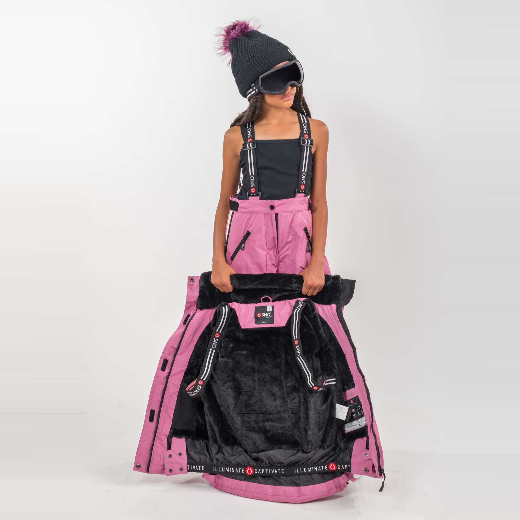 Person holding a large pink and black jacket against a white background