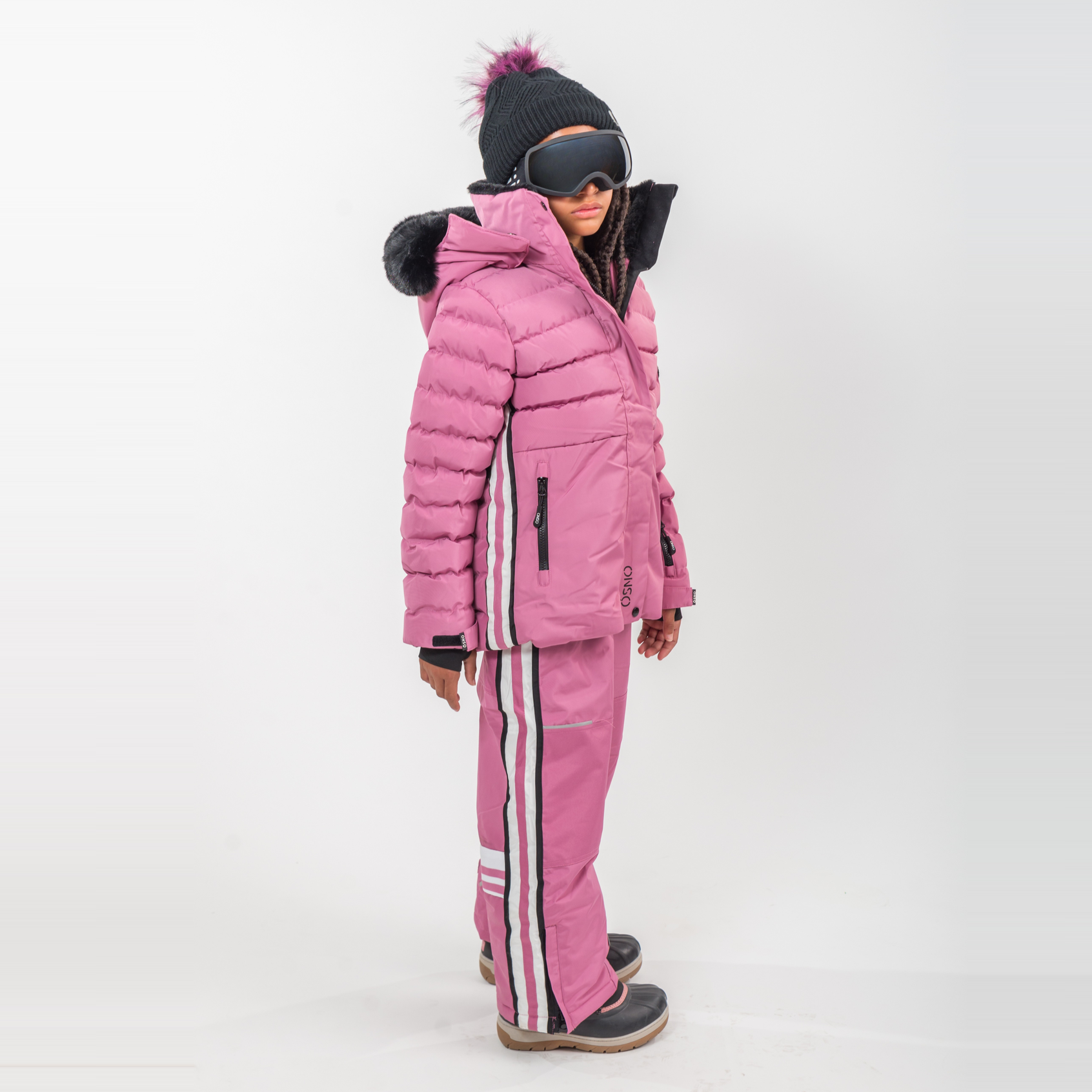 Person wearing a pink winter outfit with a matching jacket and pants on a white background