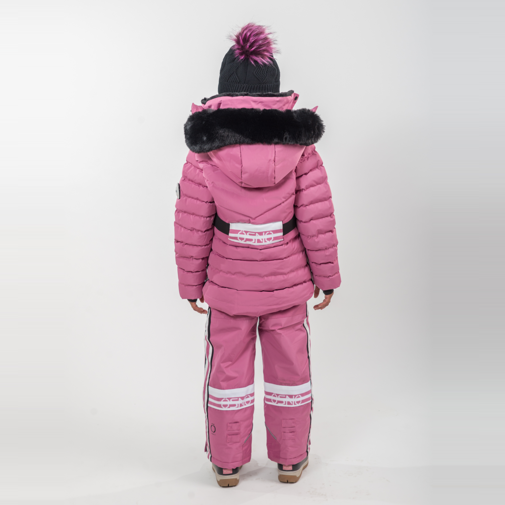 Child wearing a pink snowsuit with a black fur-lined hood on a white background