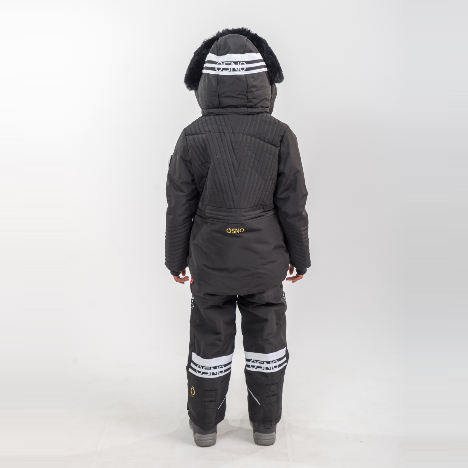 Person wearing a black snowsuit with white stripes on a white background